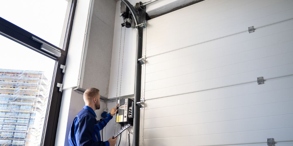 Technician addressing common garage door repair issues