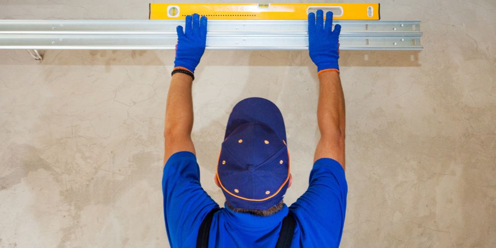 Homeowner installing a garage door opener safely