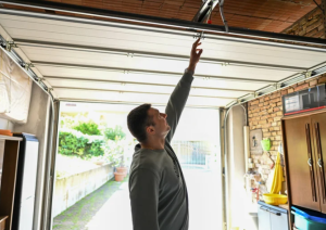 person reaching for a garage door
