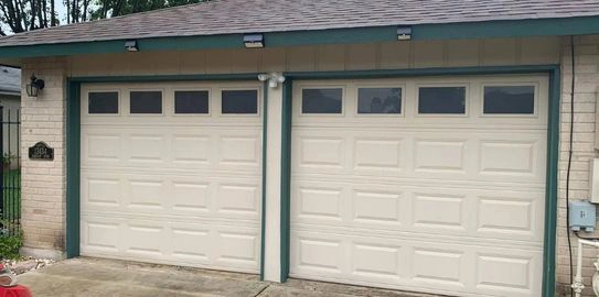Two beige garage doors with windows